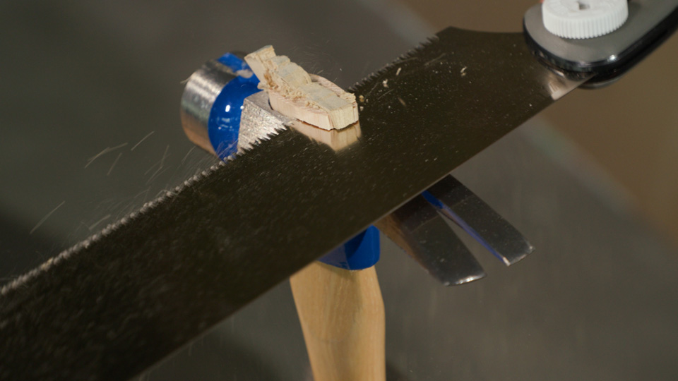 sawing off the excess wood wedge